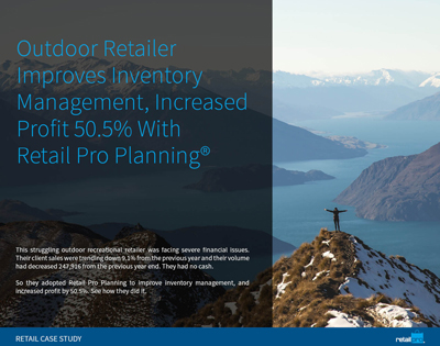 Man on mountain summit extending his arms into the air