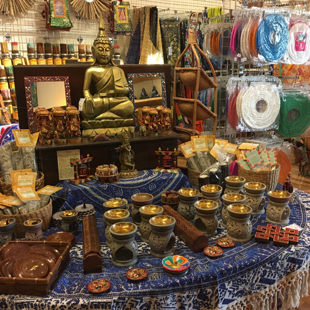 Various indie items laid out in store, with a bronze buddha
