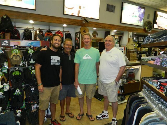 Val Surf customers and employees inside the shop, surrounded by flip-flops and other surf apparel
