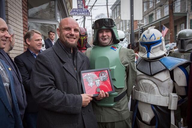 Toy store owner receiving an award