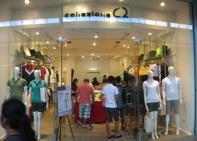 Retail storefront with glass doors and walls with mannequins on display behind them