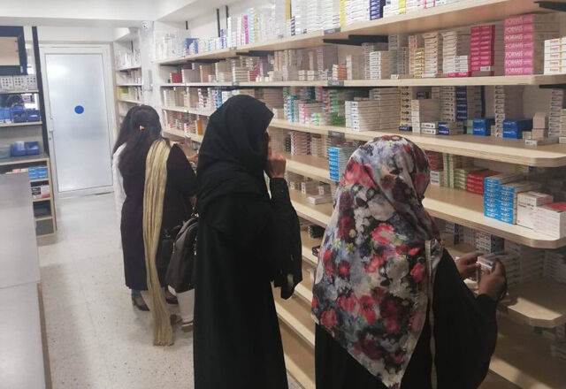 Customers in Ehad Pharmacy looking at medicine