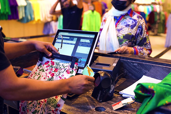 Cashier using Retail Pro Prism to checkout a customer