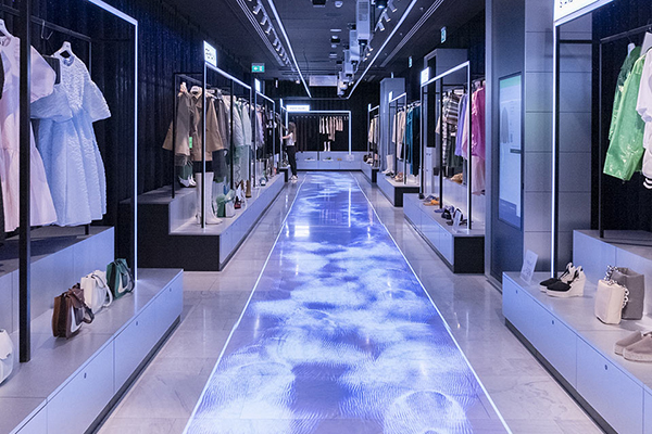 Aisle of clothes for sale inside WOW store