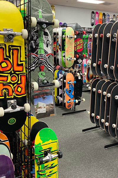 Racks of skateboards for sale inside store