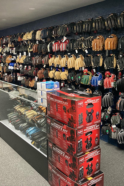 Wall of baseball gloves for sale inside store