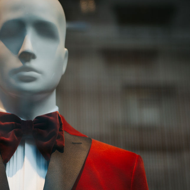 Mannequin with red suit and maroon bow tie