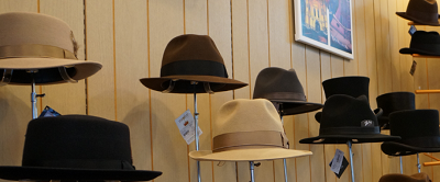 Interior view of many old fashioned stylish hats on display
