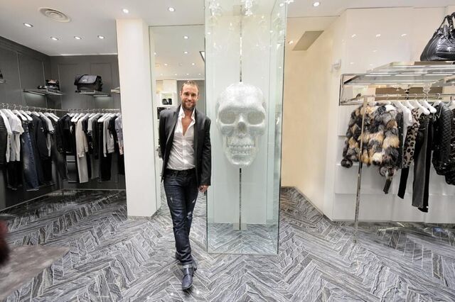 Man welcoming you to the entrance of a high-end retail store