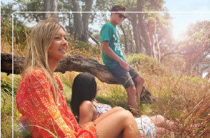 Youths hanging out on a grassy hillside in the sun