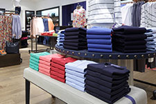 colorful, crisp clothing stacked cleanly on tables